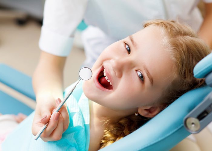 Little,Girl,Sitting,In,The,Dentists,Office